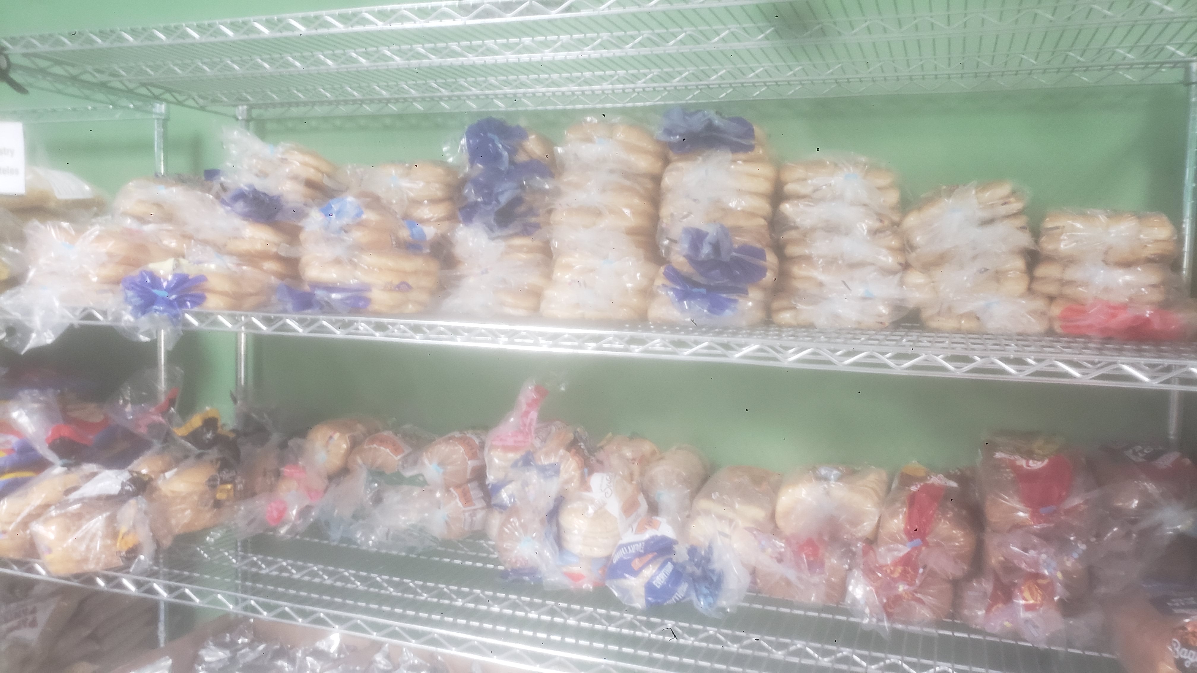 Various breads on a shelf.